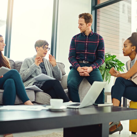 employees discussing workplace mental health benefits during a team wellness meeting