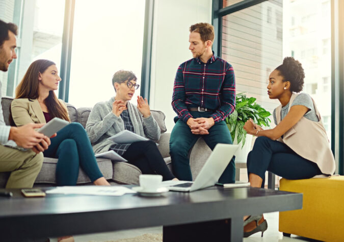 337625 employees discussing workplace mental health benefits during a team wellness meeting