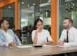 Benefits professionals reviewing employee benefit plans and ERISA fiduciary responsibilities during a corporate meeting.