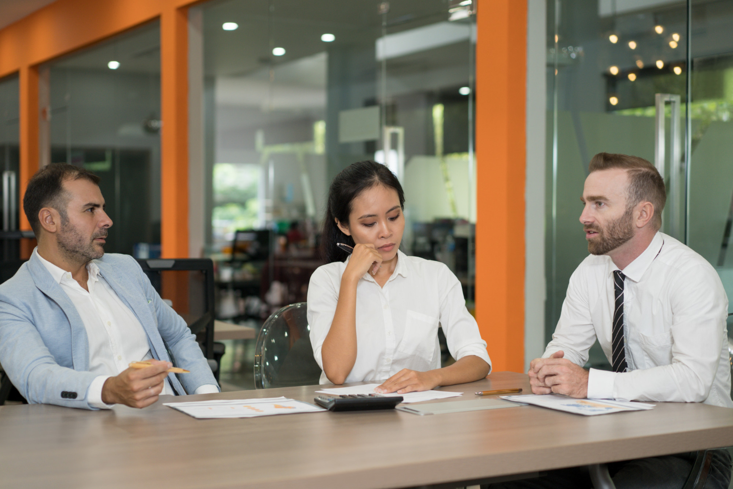 Benefits professionals reviewing employee benefit plans and ERISA fiduciary responsibilities during a corporate meeting.